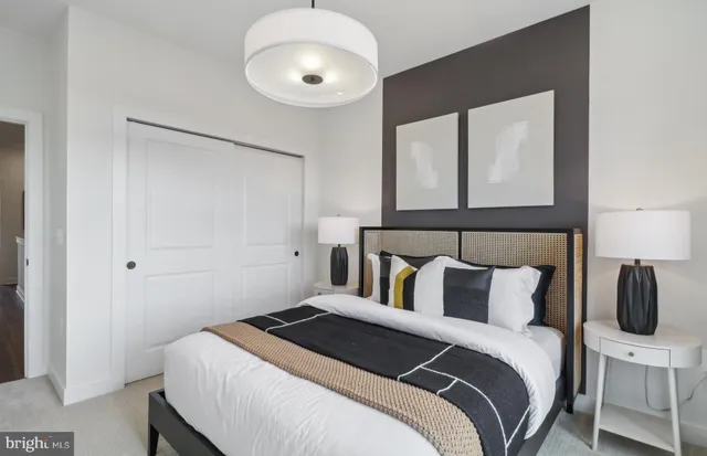 a bedroom with a large bed and a large window