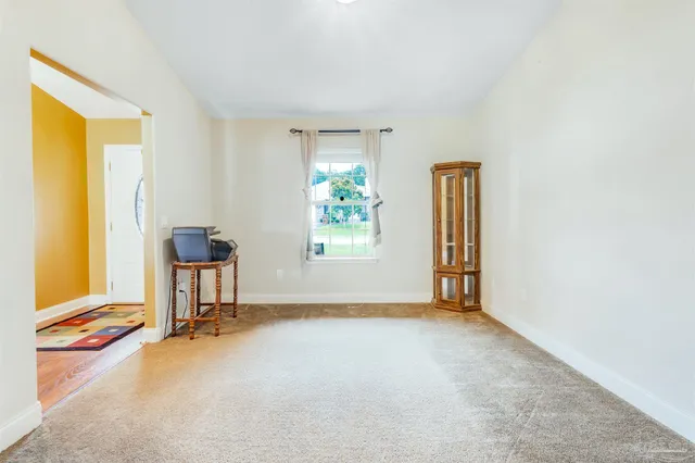 a living room with furniture rug and kitchen view