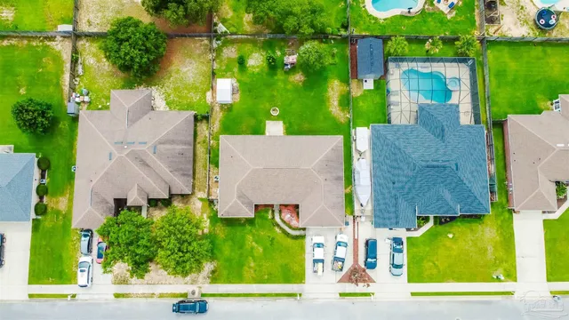 an aerial view of multiple houses with a yard