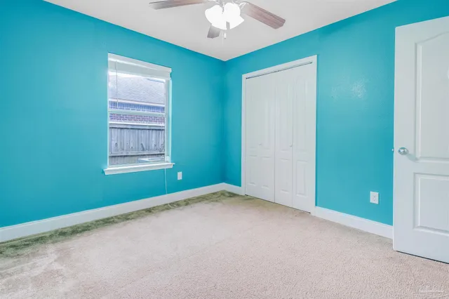 a bathroom with a granite countertop sink a toilet and a mirror