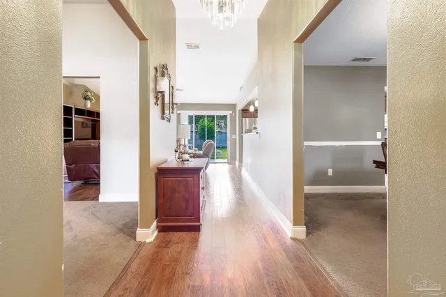 a view of a dining room with furniture wooden floor and chandelier