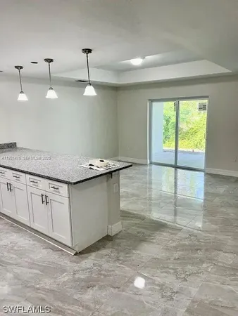 a kitchen with granite countertop a sink and a stove