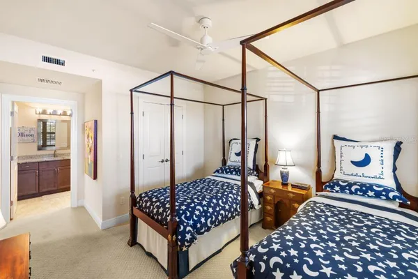 a living room with furniture a rug potted plant and a large window