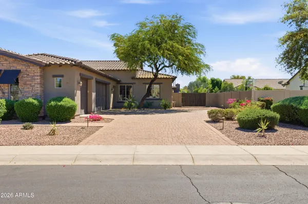 a kitchen with stainless steel appliances kitchen island granite countertop a refrigerator a stove a sink a dining table and chairs with wooden floor
