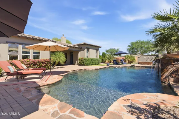 a living room with furniture a dining table and a chandelier