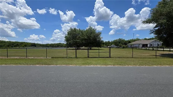 a view of a golf course with a big yard