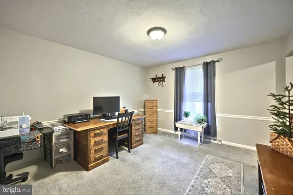 a view of a workspace with furniture and a livingroom