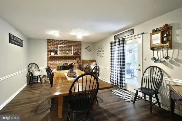 a view of a a dining room with furniture window and wooden floor