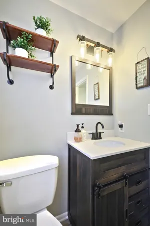 a bathroom with a toilet sink and mirror