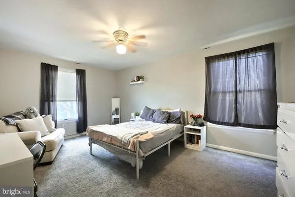 a bedroom with furniture and a flat screen tv