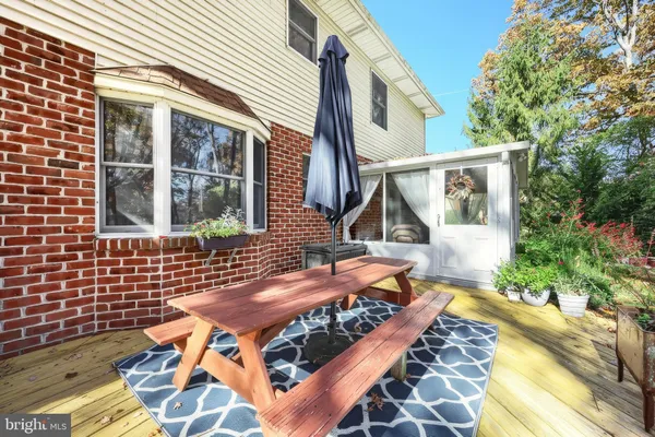 a view of a wooden deck and a yard