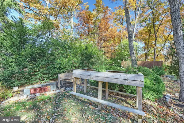 a backyard of a house with barbeque oven table and chairs