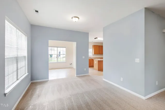 a view of a room with a empty room and a window