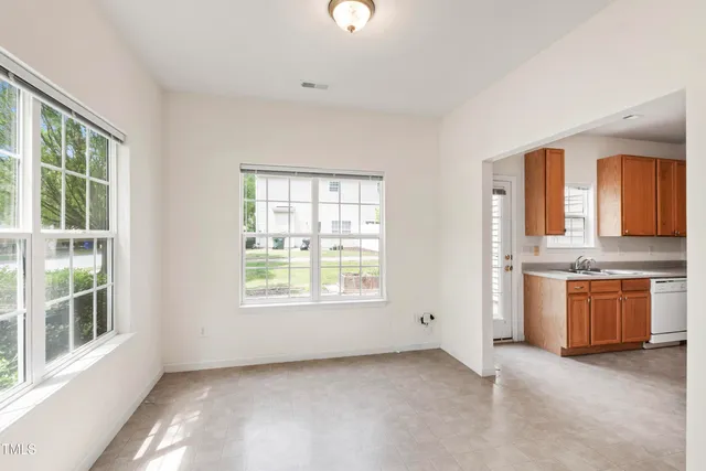 a view of an empty room with a kitchen