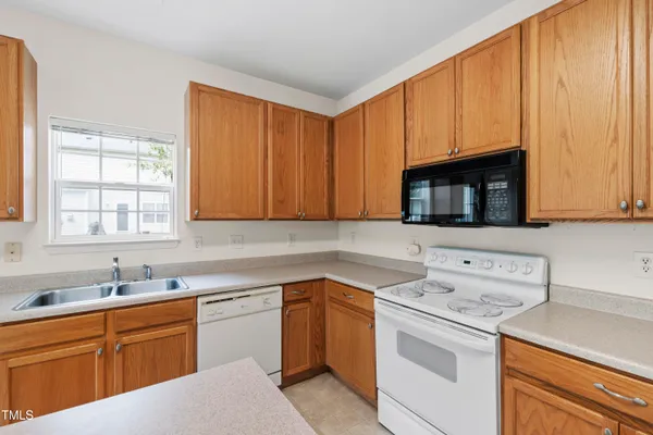 a kitchen with a sink stove and microwave