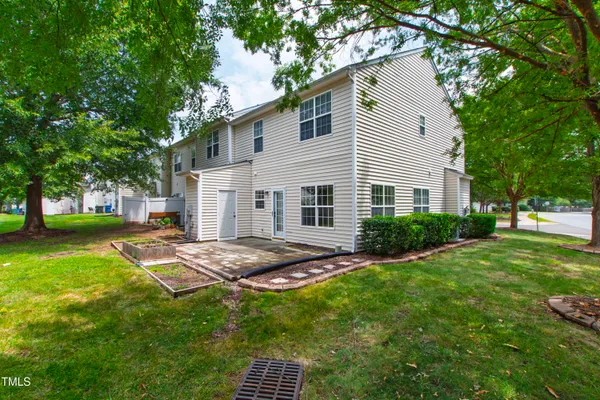 a view of backyard of house with green space