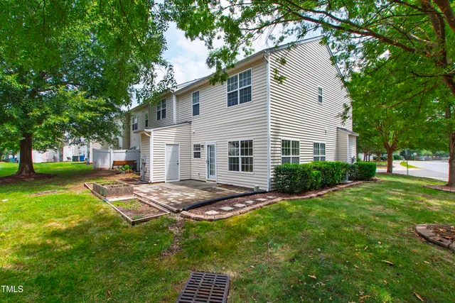 a view of backyard of house with green space