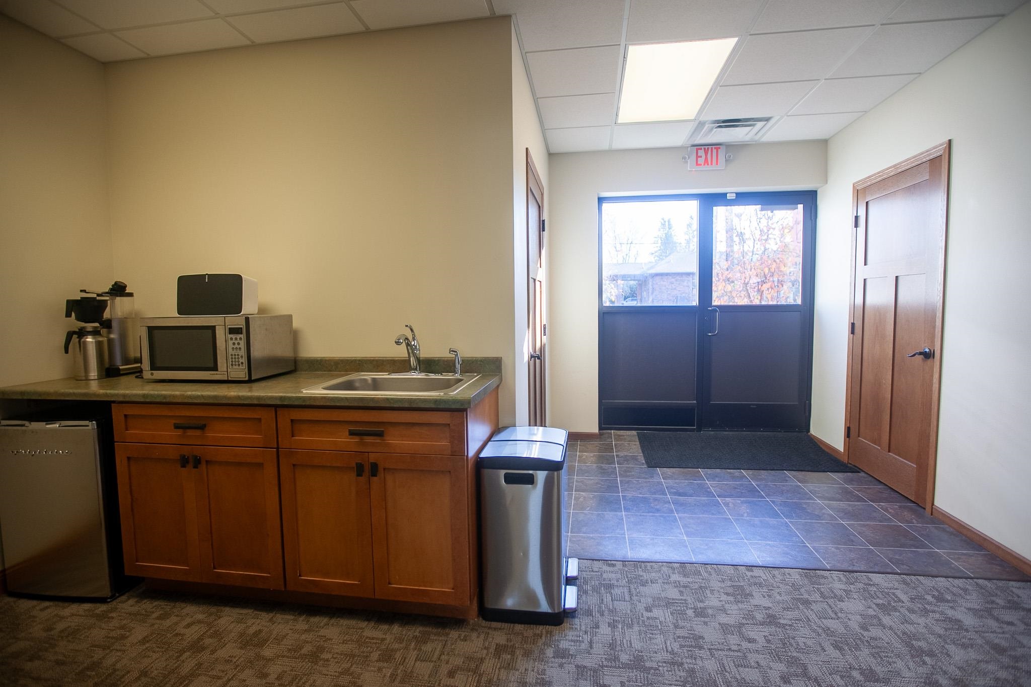 408 4th Street Moose Lake, MN 55767 - Photo 23 of 31 Kitchen featuring a drop ceiling, dark countertops, appliances with stainless steel finishes, and brown cabinetry