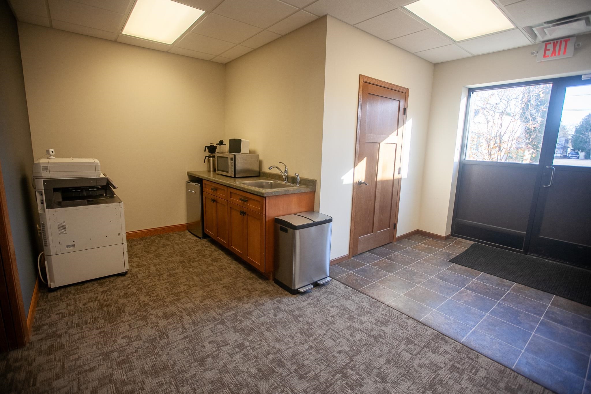 408 4th Street Moose Lake, MN 55767 - Photo 25 of 31 Kitchen with brown cabinetry, a drop ceiling, appliances with stainless steel finishes, and dark countertops