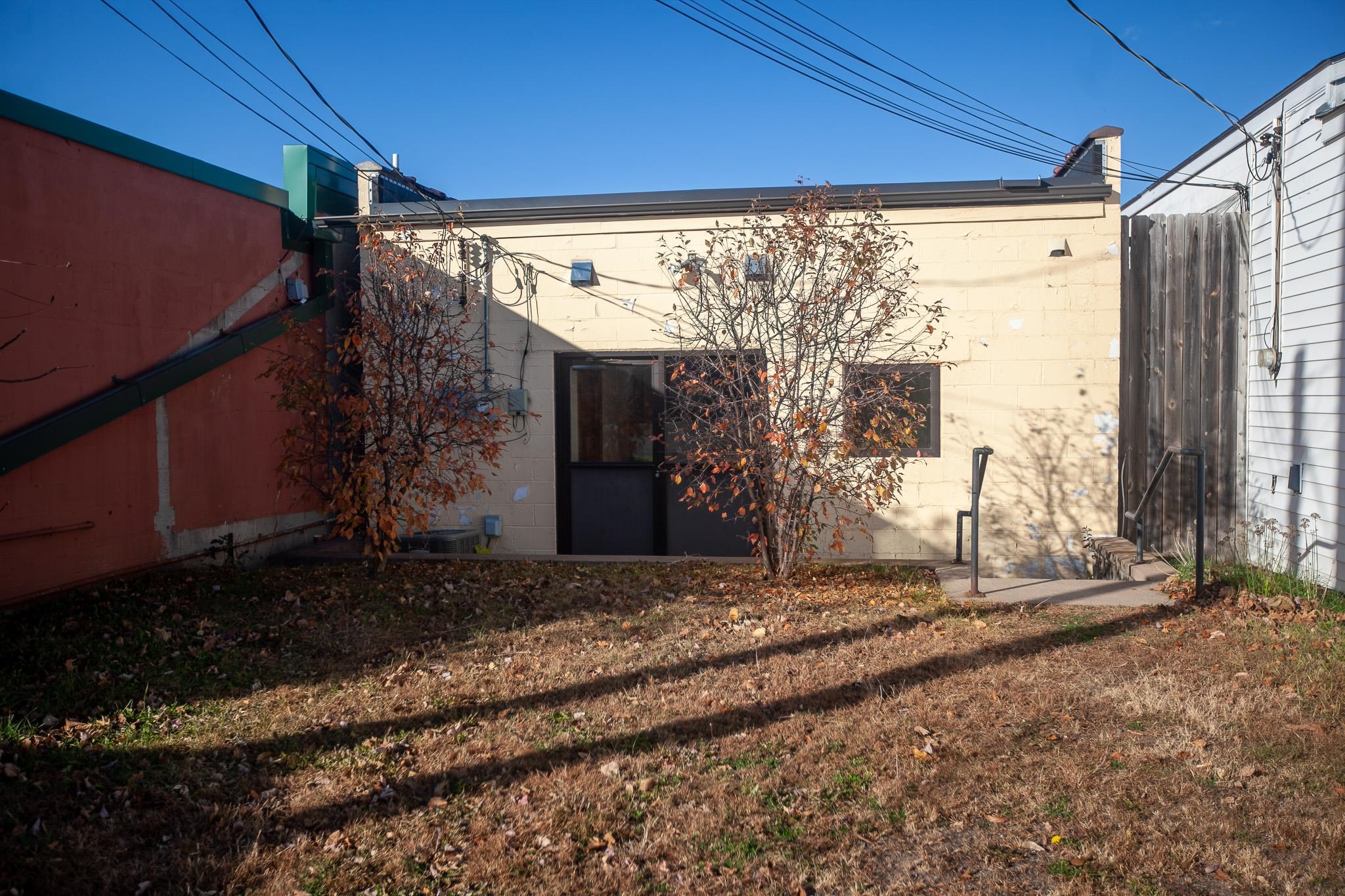408 4th Street Moose Lake, MN 55767 - Photo 29 of 31 Back of house featuring concrete block siding and a yard