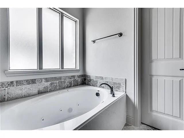 908 Lake Meadow Lane Little Elm, TX 75068 - Photo 12 of 14 a bathroom with a bathtub and a shower