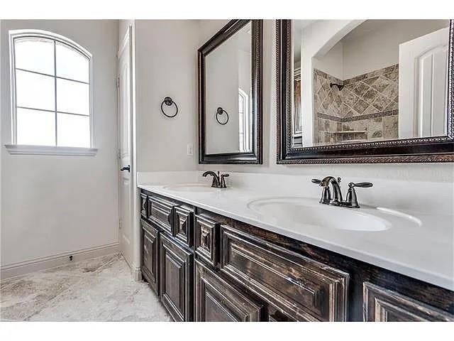 908 Lake Meadow Lane Little Elm, TX 75068 - Photo 13 of 14 a bathroom with a sink and a mirror