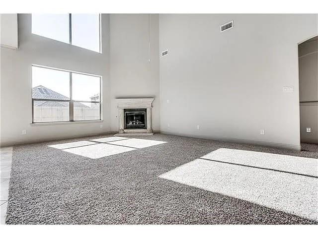 908 Lake Meadow Lane Little Elm, TX 75068 - Photo 3 of 14 an empty room with windows and fireplace