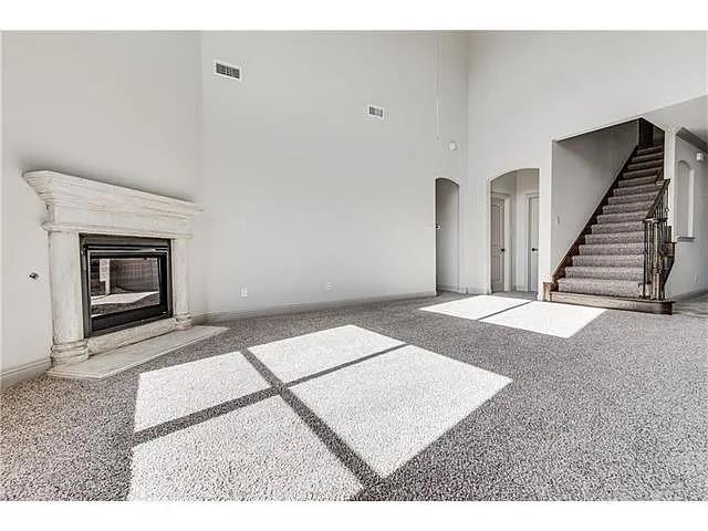 908 Lake Meadow Lane Little Elm, TX 75068 - Photo 4 of 14 a view of an empty room with wooden floor and a fireplace