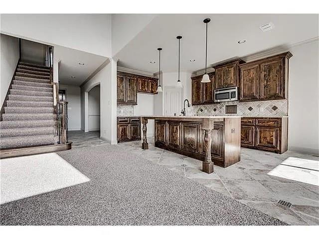 908 Lake Meadow Lane Little Elm, TX 75068 - Photo 7 of 14 a large kitchen with stainless steel appliances granite countertop a stove and a sink