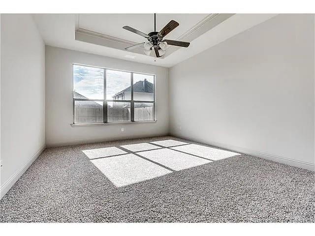 908 Lake Meadow Lane Little Elm, TX 75068 - Photo 9 of 14 an empty room with windows and ceiling fan