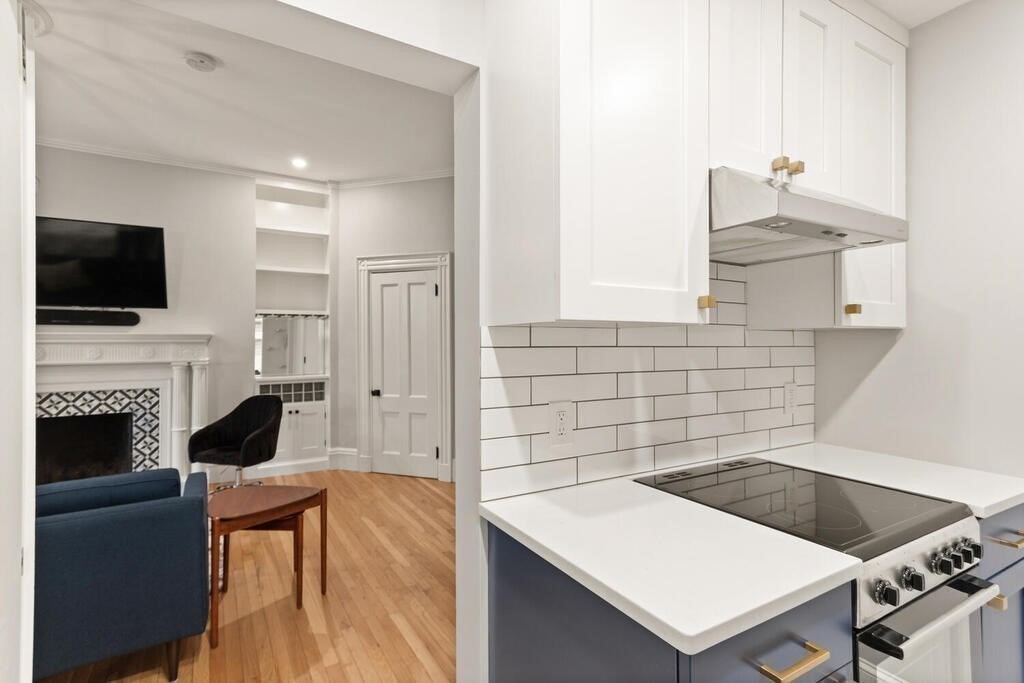 473 Beacon Street, Unit 5 Boston, MA 02115 - Photo 11 of 21 a kitchen with a stove a sink and a refrigerator
