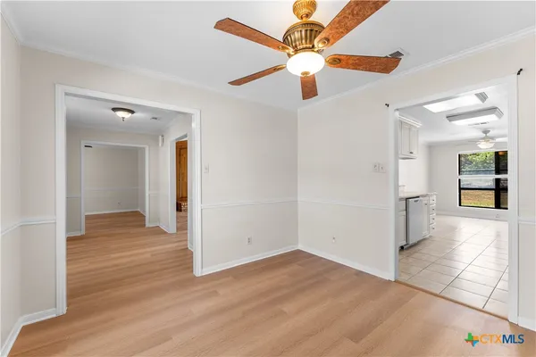 wooden floor in an empty room with a kitchen