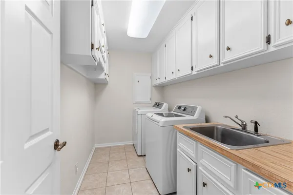 a kitchen with stainless steel appliances granite countertop a sink and dishwasher with white cabinets