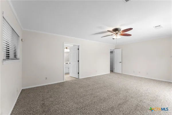 a view of an empty room with a fan