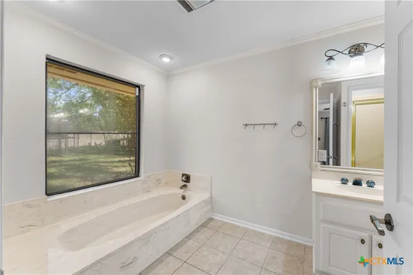 a bathroom with a bathtub and a sink