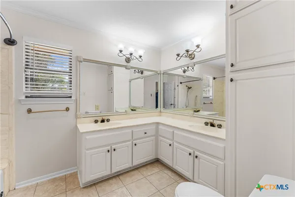 a bathroom with a tub sink shower and mirror