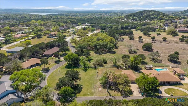 an aerial view of residential houses with outdoor space and river