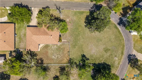 an aerial view of a residential houses with outdoor space