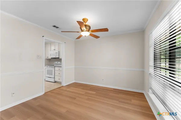 a view of empty room with wooden floor