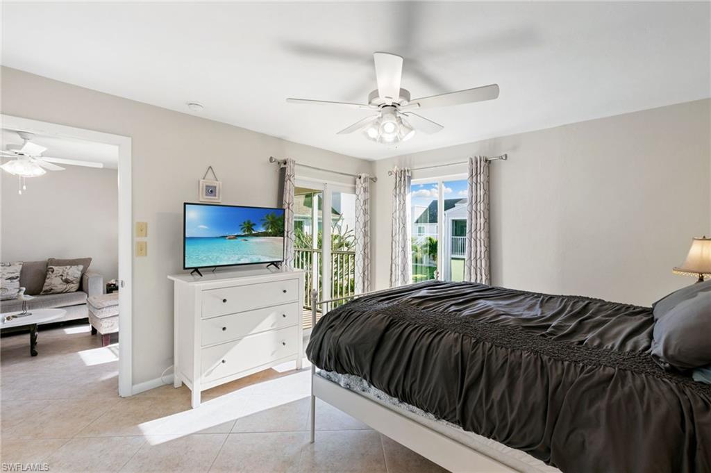 2149 San Marco Road, Unit 201 Marco Island, FL 34145 - Photo 11 of 22 a bedroom with a bed and a flat tv screen on dresser