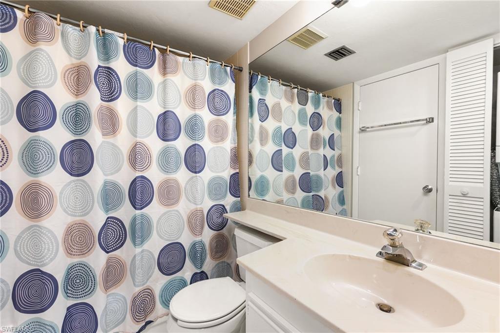2149 San Marco Road, Unit 201 Marco Island, FL 34145 - Photo 14 of 22 a bathroom with a sink and mirror with toilet