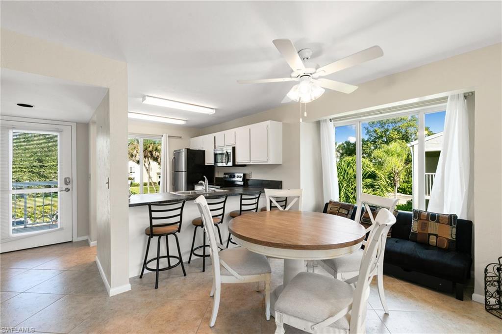 2149 San Marco Road, Unit 201 Marco Island, FL 34145 - Photo 6 of 22 a view of a dining room with furniture window and outside view