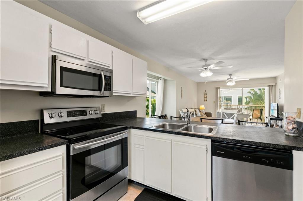 2149 San Marco Road, Unit 201 Marco Island, FL 34145 - Photo 9 of 22 a kitchen with a sink stove and microwave
