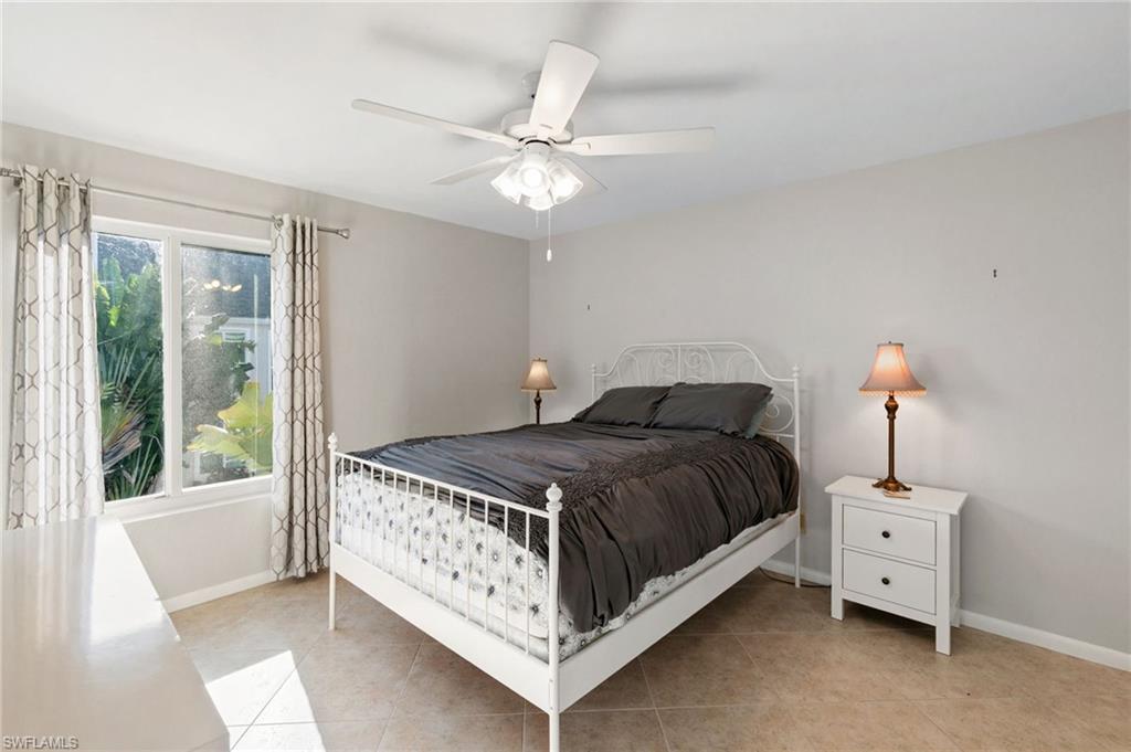 2149 San Marco Road, Unit 201 Marco Island, FL 34145 - Photo 10 of 22 a bedroom with a bed and a chandelier