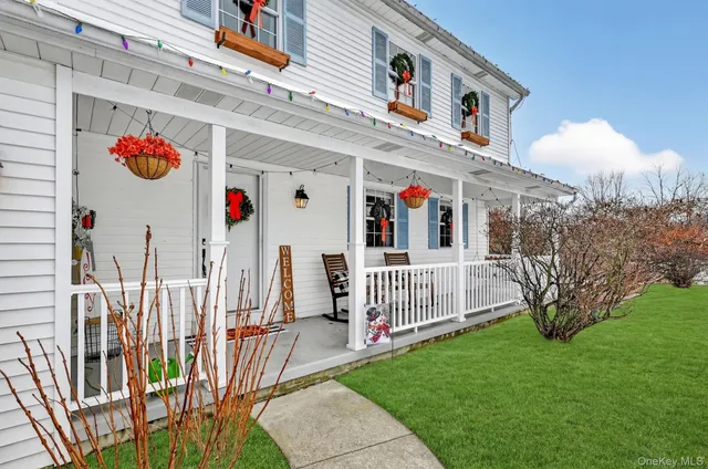 a view of a patio with table and chairs a barbeque with a floor to ceiling window