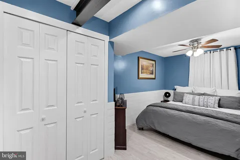 a bedroom with a bed and a couch