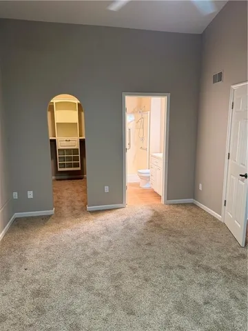 an empty room with a window and a mirror