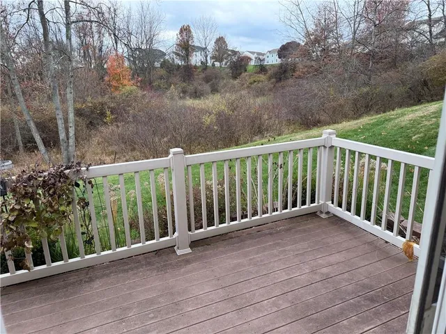 a view of balcony with wooden floor and fence