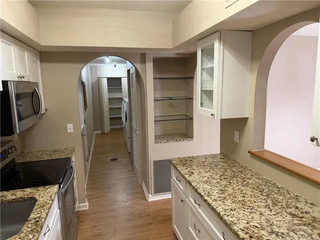 a kitchen with a refrigerator and a stove