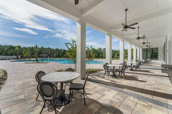 a view of a swimming pool with outdoor seating and lake view